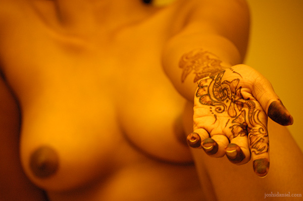Fine art nude of a girl with mehndi on her hands