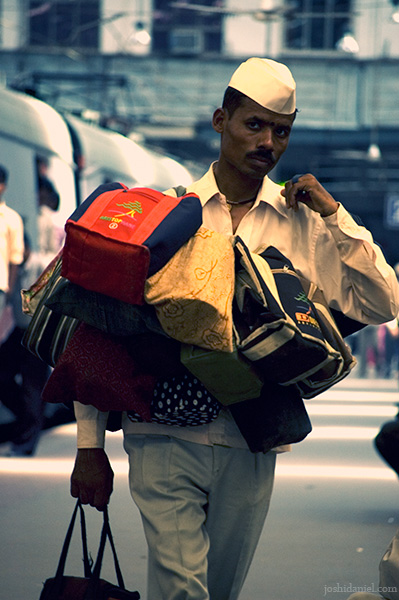 A dabbawala with tiffin boxes at Churchgate railway station, Mumbai, India