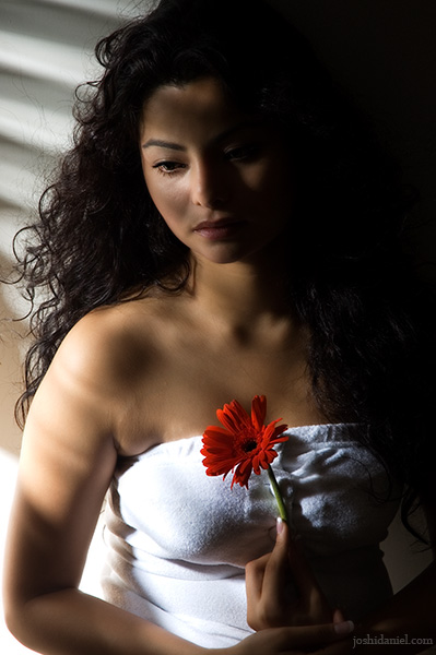 Moody portrait of female model Konkana Bakshi holding a flower