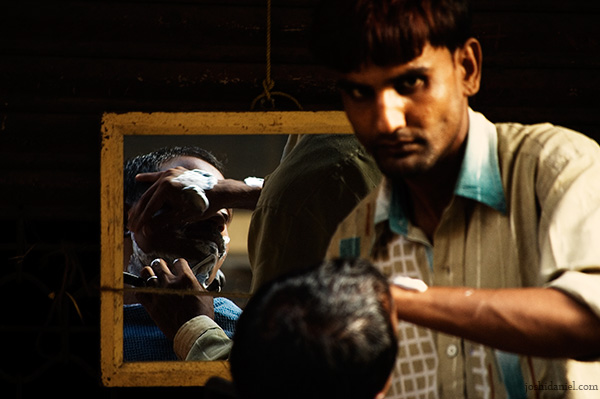 Roadside Barber A roadside barber at work in Chor Bazaar, Mumbai, India