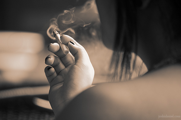 A girl smoking cigarette in Starbucks coffee in Berjaya Times Square, Kuala Lumpur, Malaysia