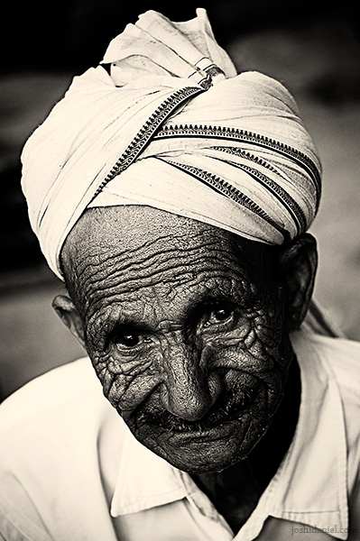 A mysterious smile portrait of an old man with wrinkled face from Mcleod Ganj, Dharamsala, India