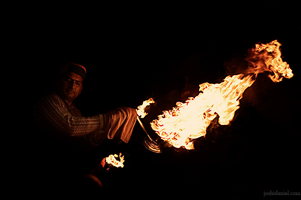 A priest holds a large fire bowl in his hand during an evening aarti at har ki pauri in Haridwar