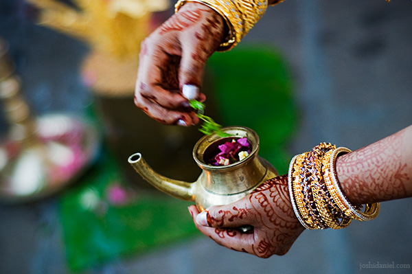 Bride Chandini Madhavan performing a ritual from a South Indian wedding