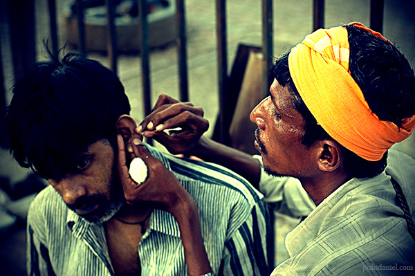 A traditional ear cleaner at work in streets of Bandra in Mumbai