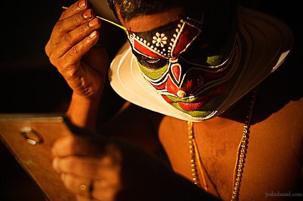 A kathakali artist doing make-up