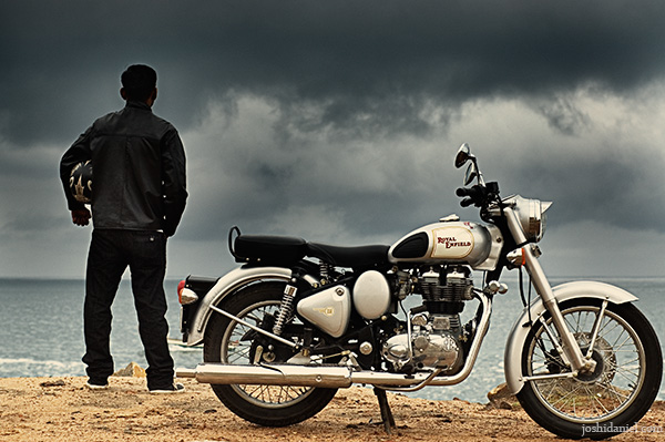 A biker standing near his royal enfield classic 350 enjoying a solitary moment