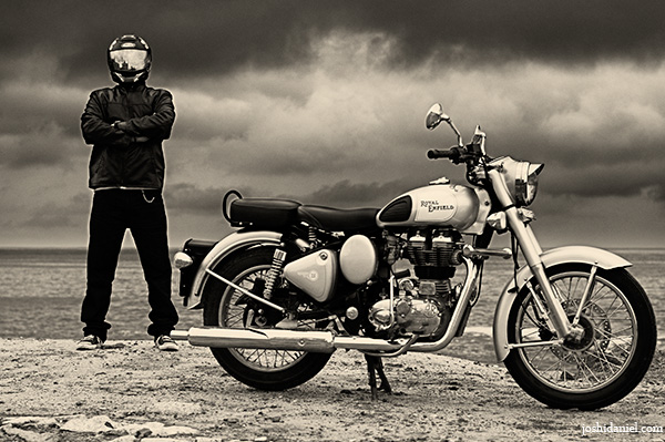 Anuroop Nair with his royal enfield classic 350 on a cloudy day