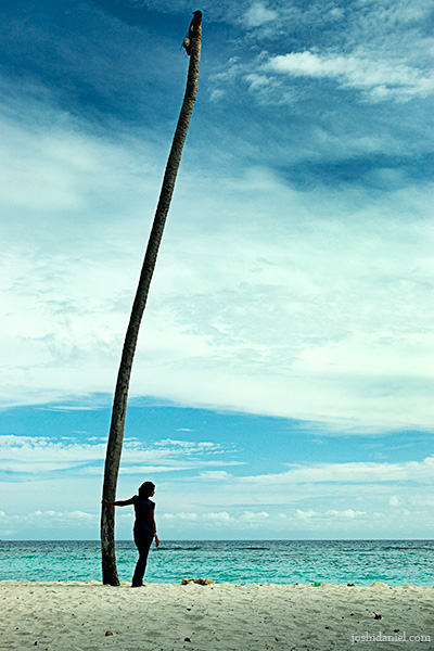 A girl standing near a coconut tree in Villingili island in Maldives