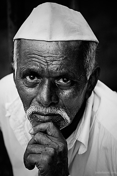 Attitude creates character Black and white portrait of a Marathi man with topi holding his chin