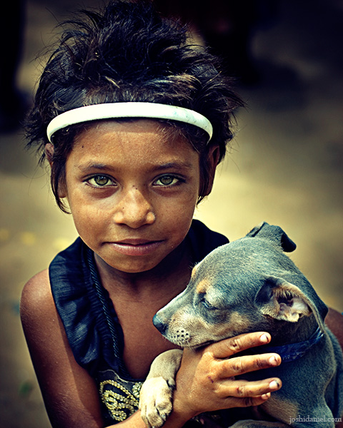 Portrait of little girl from Tamil Nadu with her puppy