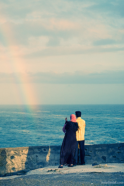 Couple watching rainbow at Vizhinjam, Kerala, India