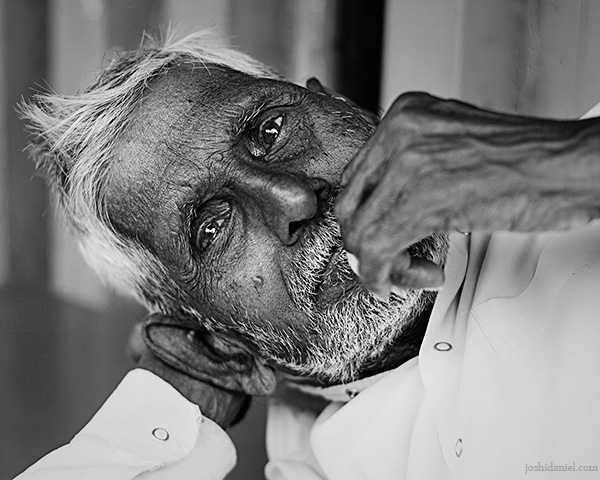 Laid back black and white portrait of an old man from Pune