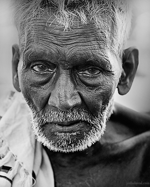 Black and white street portrait of an old man from Tamil Nadu, India