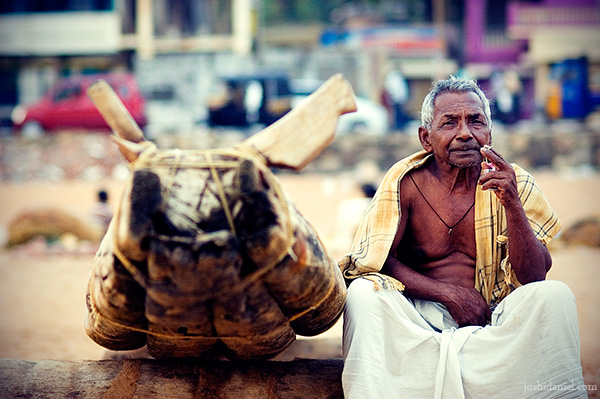 A fisherman sitting near a catamaran at Shankhumugham, Trivandrum