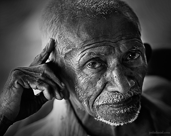 Black and white portrait of a an old man from Fort Kochi in Kerala, India