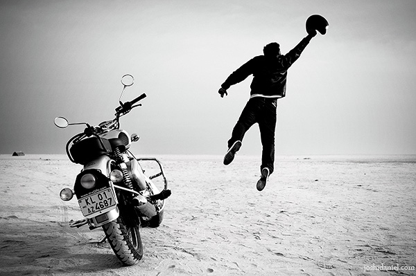 A biker jumping near his Royal Enfield classic 350 in Trivandrum