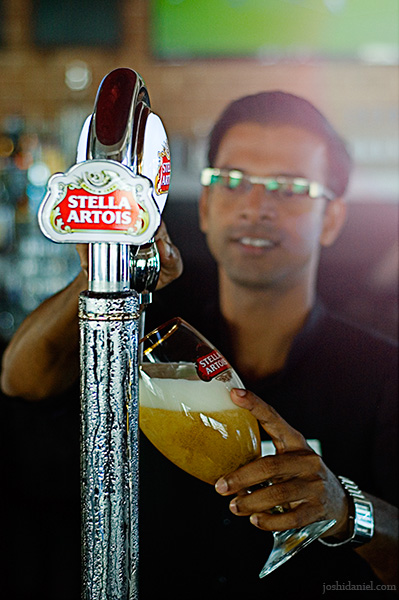 A bartender filling the glass with Stella Artois from tap at Courtyard by Marriott Dubai