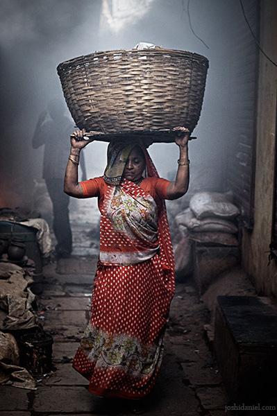 A woman from Dharavi carrying a basket on her head