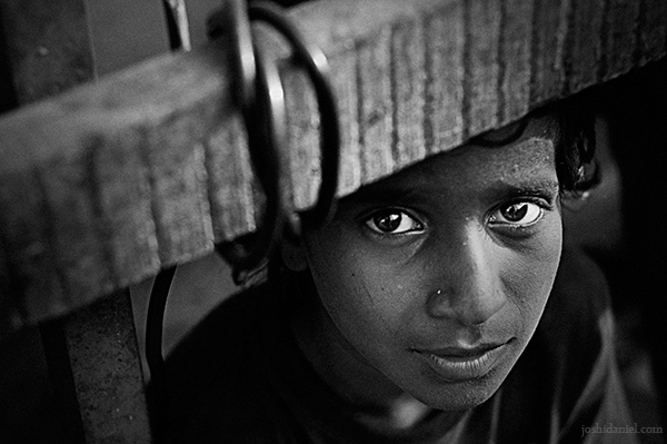 Black and white portrait of a young boy from a street in Mumbai