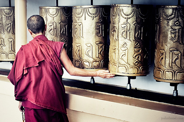 Buddhist monk rotating a mani Prayer Wheel at McLeod Ganj, Dharamsala, India