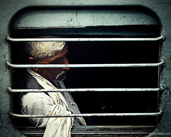Portrait of a Maha Kumbh Mela pilgrim in Allahabad through a train window
