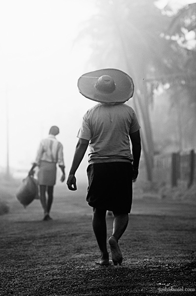 Treading on Black and white photograph of a fisherman walking from Kannur, India