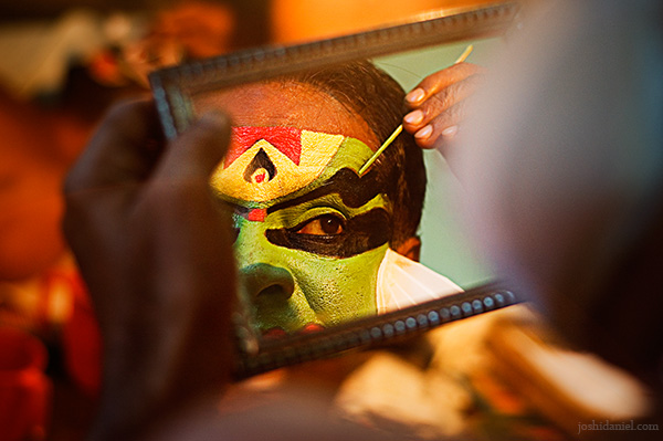 Reflection of a kathakali artist doing make-up