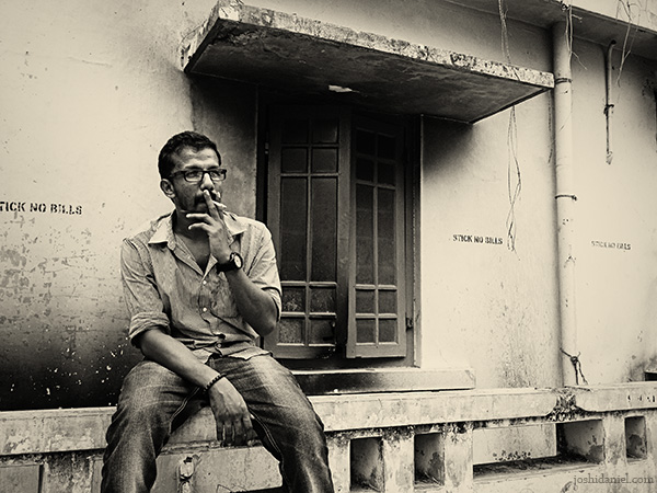 Black and white portrait of Chandrakanth C K smoking cigarette
