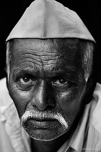 Black and white portrait of a Marathi man with topi from Pune, India