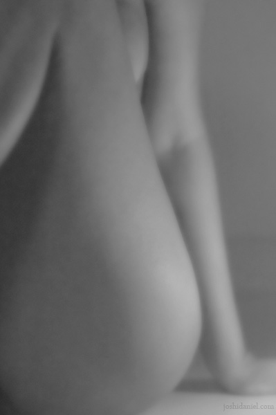 Black and white fine art nude of a seated girl