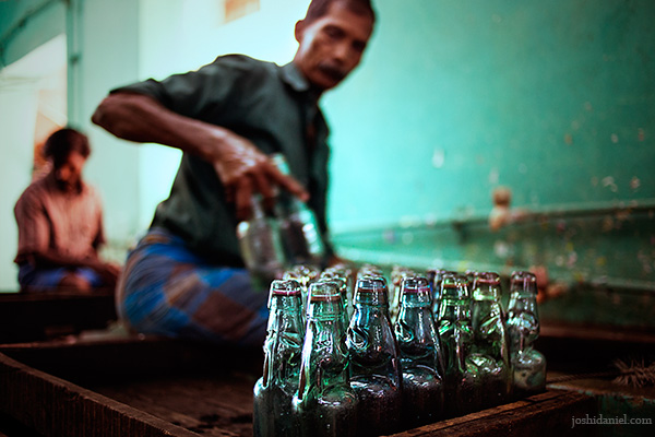 A worker cleaning Goli soda bottles at Vasu and Co., Chennai