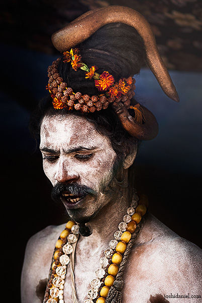 Naga Sadhu with a two-headed snake wrapped around his head in Varanasi