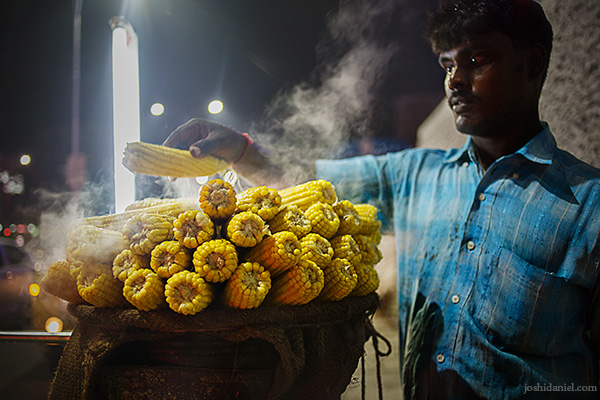 A man selling freshly steamed corn at Chennai, India