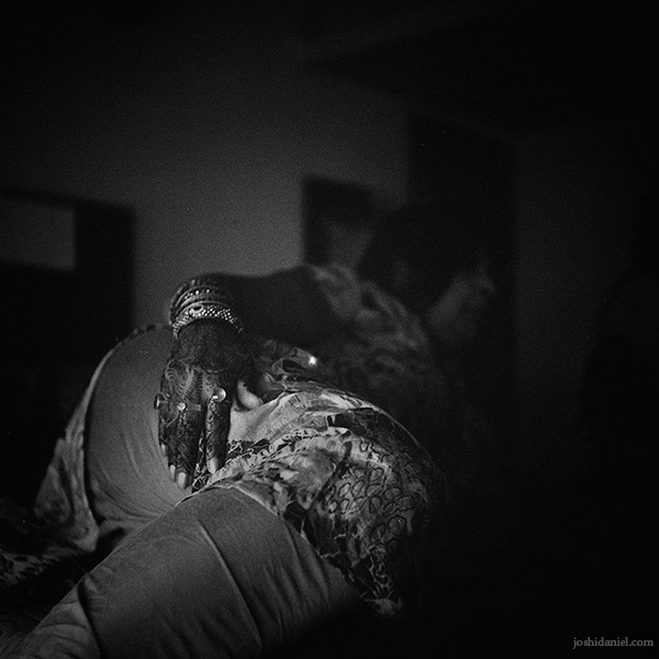 Black and white photograph of a lady’s hands painted with mend for a wedding