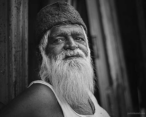 Black and white portrait of an old man trading in scrap in Madiwala, Bangalore