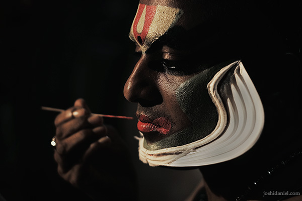 Portrait of a Kathakali artist from Trivandrum, Kerala applying make-up