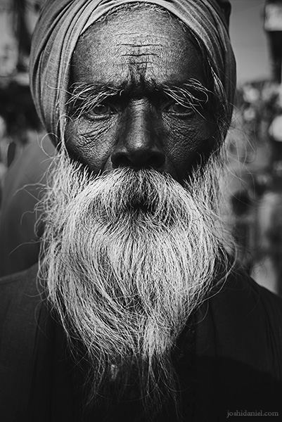 Black and white portrait of a sadhu in Varanasi with a deadpan expression