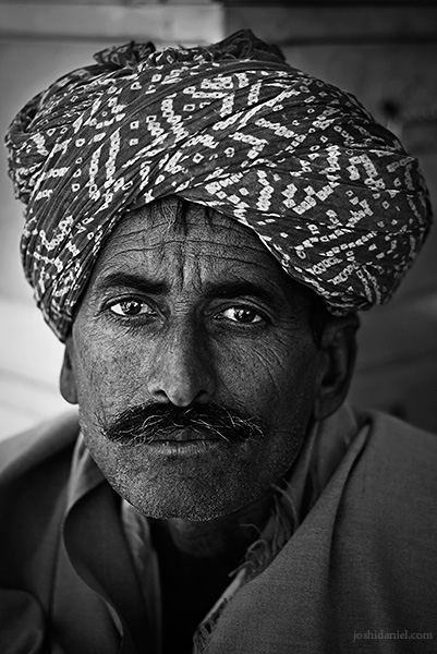 Portrait of a Rajasthani man in Jaisalmer Black and white portrait of a turban-wearing Rajasthani man in Jaisalmer