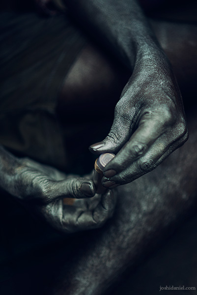 Metallic silver-coated hands of a boy selling colours during the Holi festival in Sowcarpet in Chennai