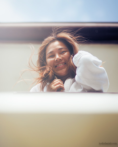 Portrait of Charlene Tan looking down from the balcony of La Prima Hotel in Labuan Bajo, Indonesia