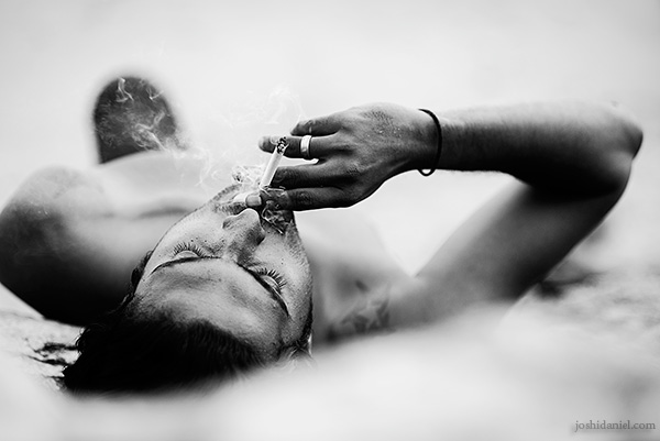 Up in smoke Black and white portrait of Abilash Thankan lying on the ground and smoking in Trivandrum, Kerala