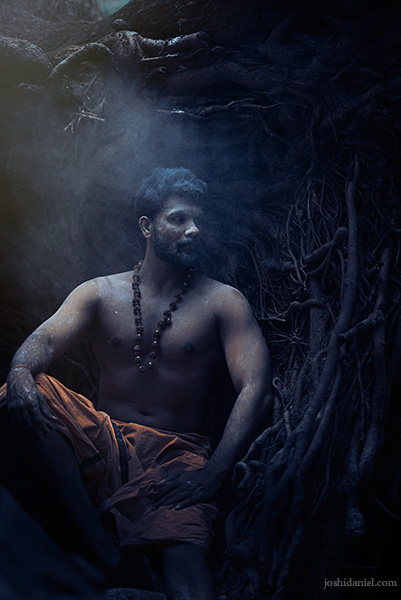 Portrait of Vivek Gopan sitting next to an uprooted tree in Kallar, Trivandrum