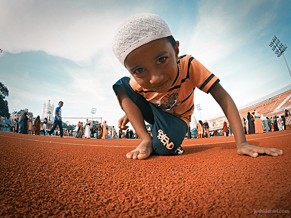 A young boy curiously looks at my GoPro during the morning Eid prayer at Chandrasekharan Nair Stadium in Trivandrum, Kerala