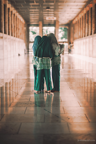 A group of young girls huddled together at Istiqlal Mosque in Jakarta, Indonesia