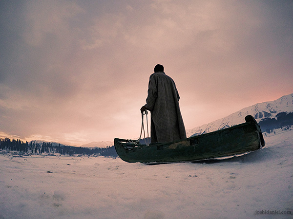 Kashmiri sled puller A Kashmiri sled puller holding the reins of the sled on a snowy evening in Gulmarg