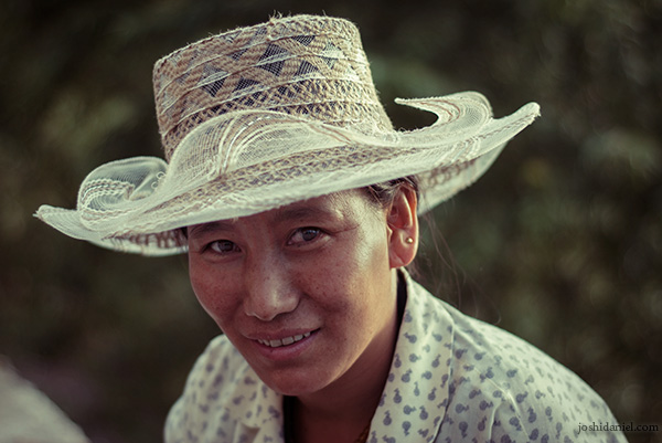 Portrait of a smiling woman in McLeod Ganj, Himachal Pradesh wearing a hat