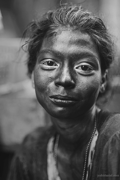 Black and white portrait of a girl covered in Holi colours in Sowcarpet, Chennai, Tamil Nadu, India