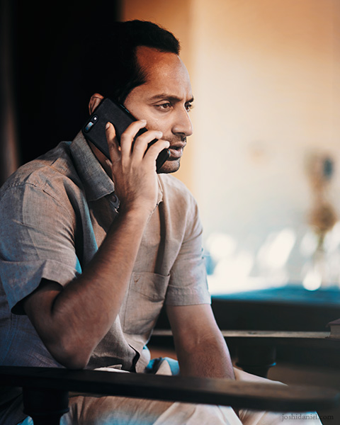 Portrait of actor Fahadh Faasil talking on the phone