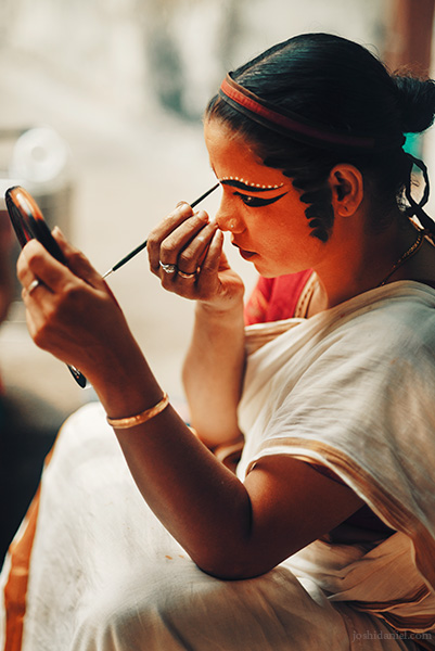 Kutiyattam ​​(Koodiyattam) artist Kalamandalam Sindhu applying make-up during a performance in Trivandrum, Kerala, India